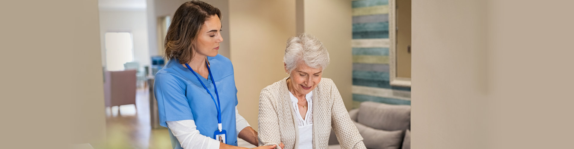 nurse helping senior woman to walk