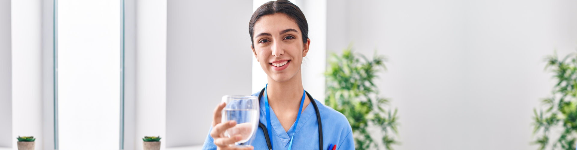 nurse holding a glass of water