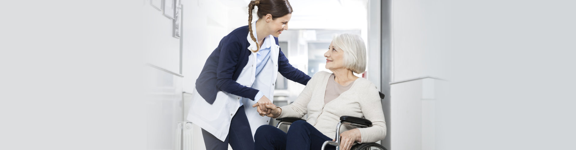 a caregiver assisting her patient while on the wheelchair