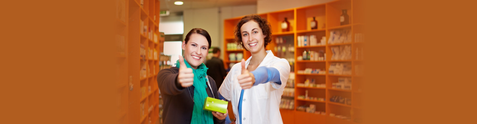 pharmacist and customer holding thumbs up in a pharmacy